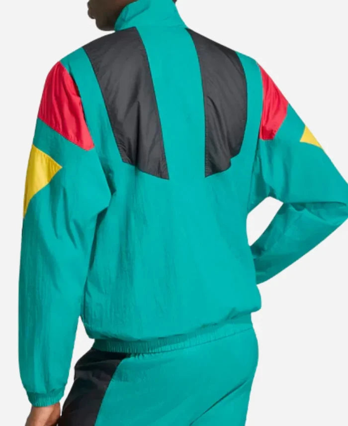 Person wearing a colorful tracksuit with green, red, yellow, and black design on a white background