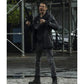 A man in a wet urban setting wearing a black leather jacket, black hoodie, dark gray jeans, and black boots, holding a rifle and shouting.