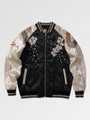 Black and beige bomber jacket with floral and bird embroidery on a light gray background