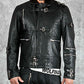 Black leather jacket with multiple zippers and buckles on a gray background