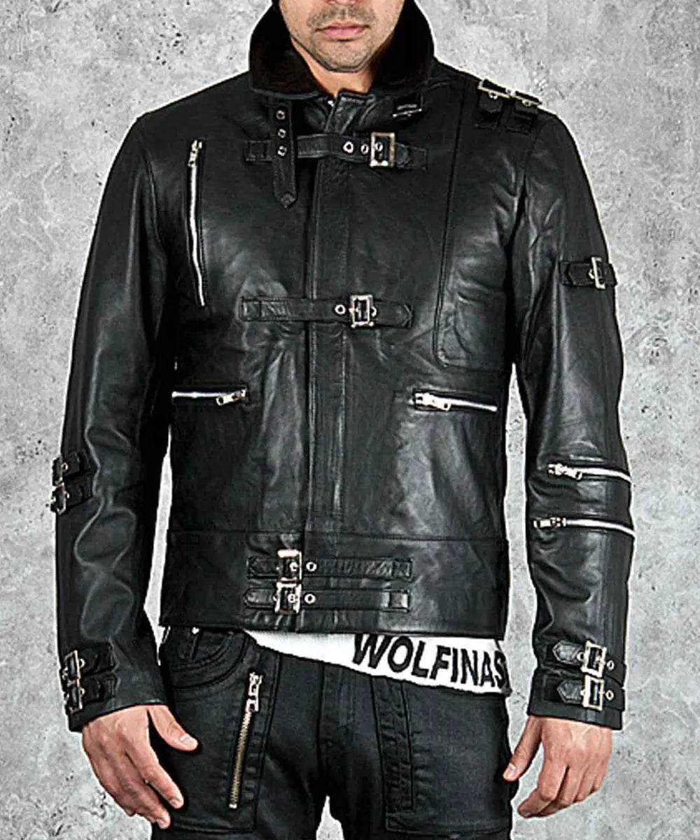 Black leather jacket with multiple zippers and buckles on a gray background