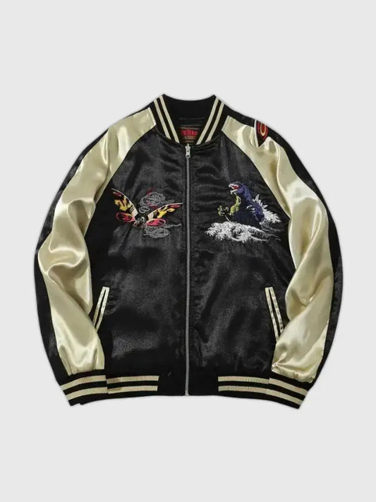 Black satin jacket with white sleeves featuring embroidered designs on a light gray background