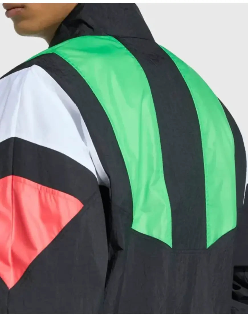 Colorful jacket with black, green, red, and white design on a plain background