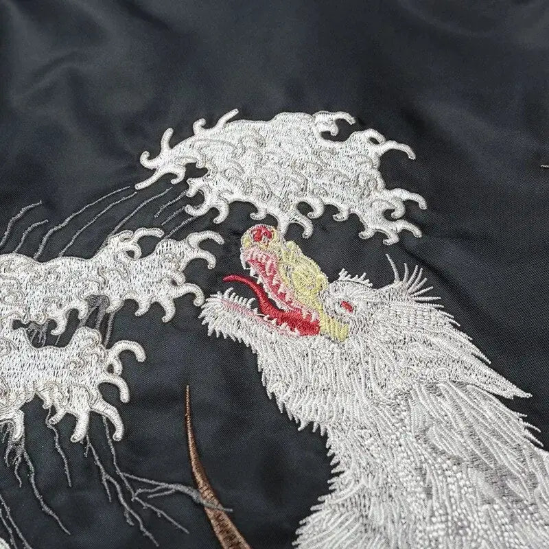 Embroidered dragon design on black fabric