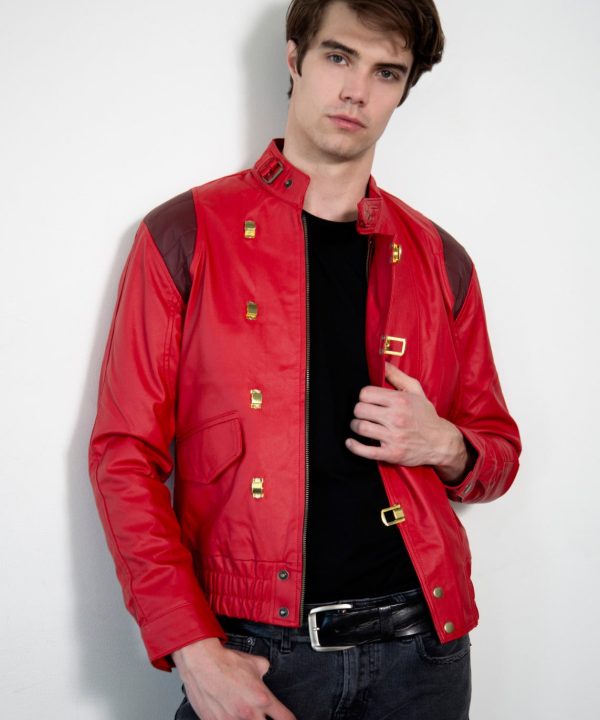 Man wearing a red jacket with gold buttons against a white background