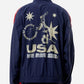 Navy blue jacket with 'USA' and star design on the back, worn by a person.
