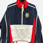 Navy, red, and white jacket with a logo on a white background