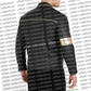 Person wearing a black hoodie with 'urban collections' branding on a patterned background.