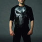 Person wearing a black outfit with a skull design on a gray background