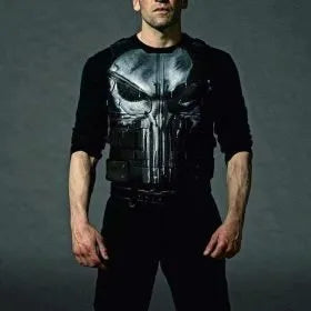 Person wearing a black outfit with a skull design on a gray background