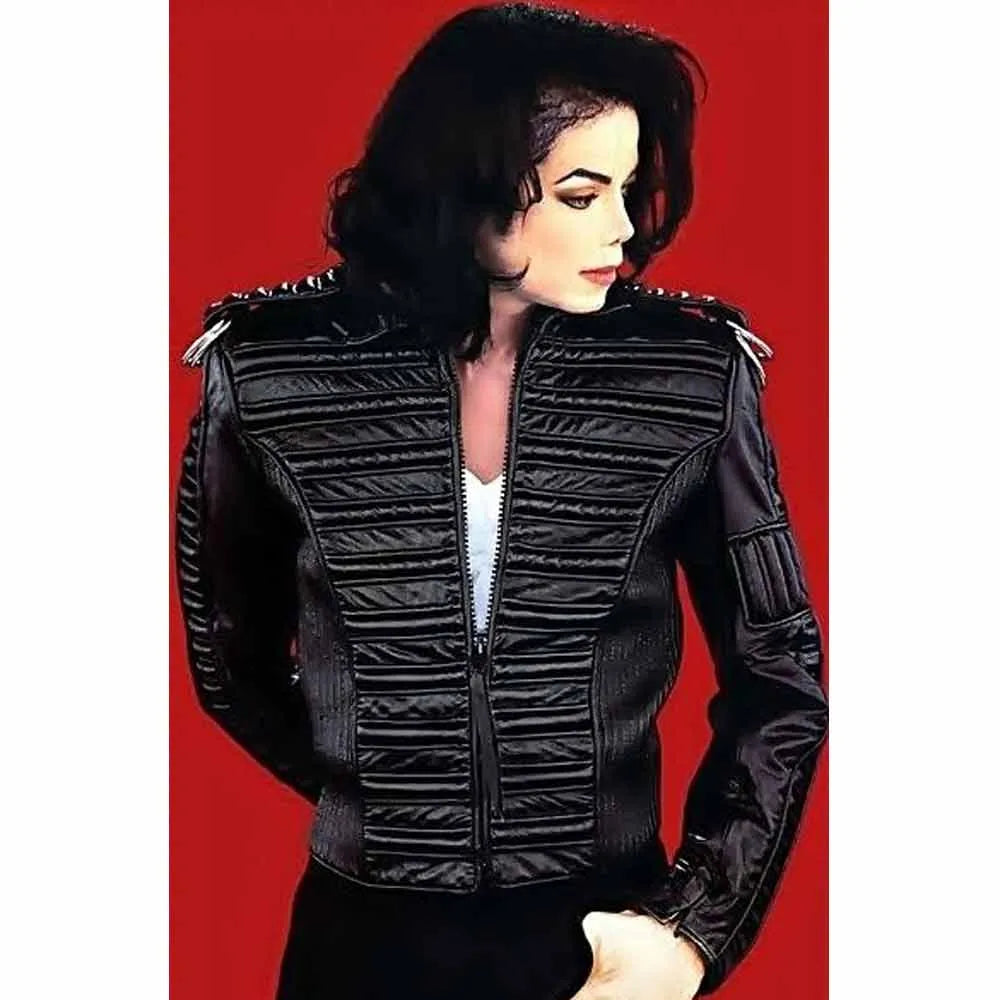 Person wearing a black quilted jacket against a red background