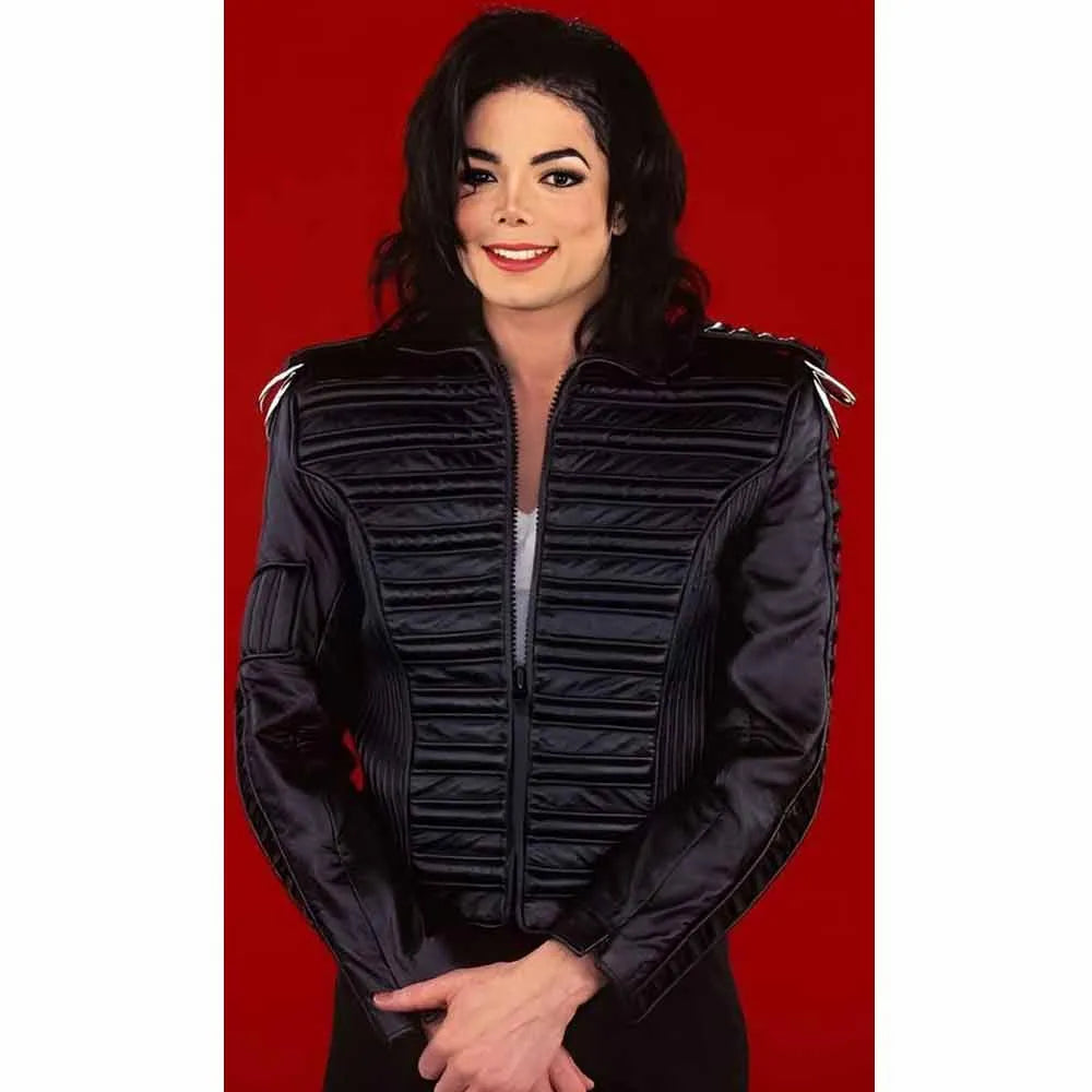 Person wearing a black quilted jacket on a red background