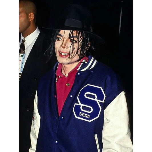 Person wearing a blue letterman jacket with a large 'S' and 'Sega' logo, standing next to another person.