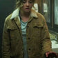 Person wearing a brown jacket with a fur-lined hood in an indoor setting