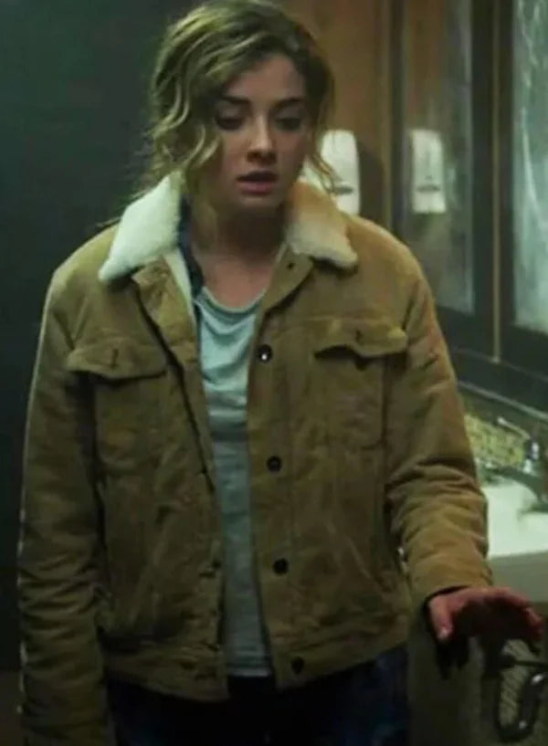 Person wearing a brown jacket with a fur-lined hood in an indoor setting