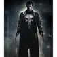 Person wearing a jacket with a skull emblem holding two guns against a dark background