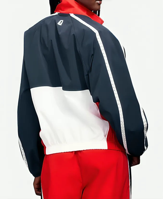 Person wearing a navy, white, and red tracksuit on a white background