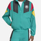 Person wearing a teal tracksuit with colorful accents on a white background