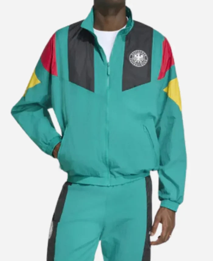 Person wearing a teal tracksuit with colorful accents on a white background