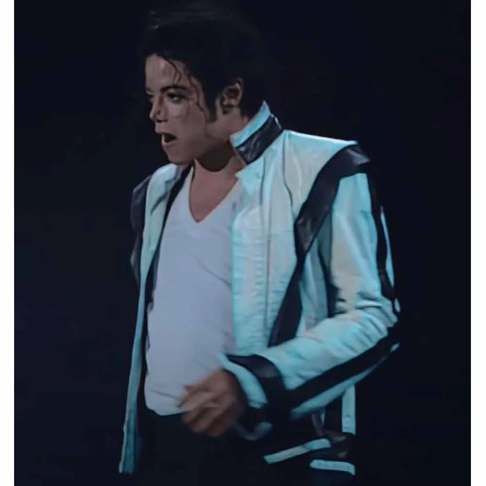 Person wearing a white jacket with black accents a dark background