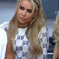 WWE Raw 2025 Nattie Neidhart Monogram White Knit Sweater — Product Description