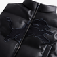 Close-up of Detroit Lions design and zipper on black faux leather cropped puffer vest