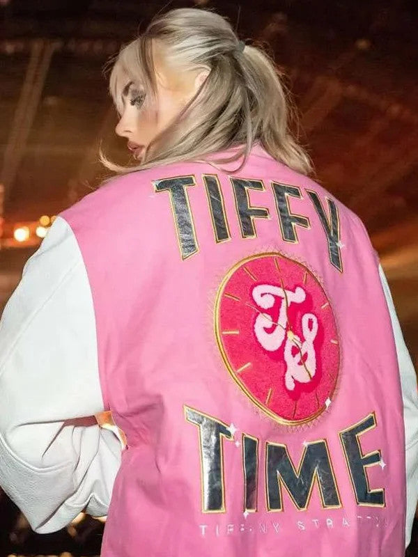 Close lifestyle front of pink full-snap varsity jacket with ribbed pink-white striped cuffs