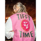 Side/three-quarter view of pink and white Tiffy Time letterman-style varsity jacket